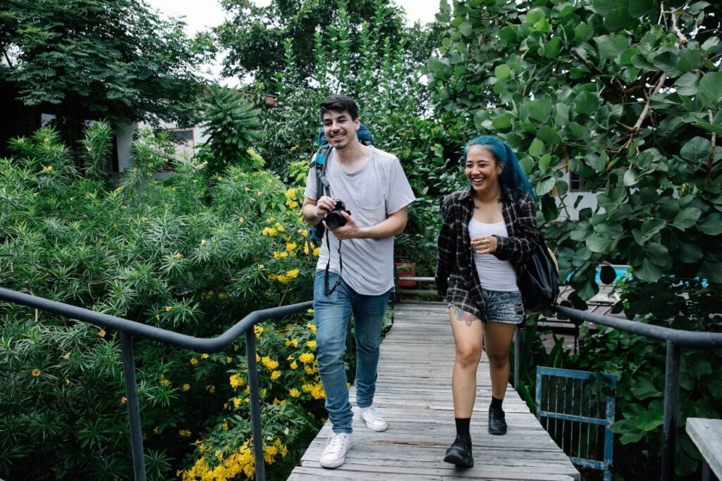 two young adults walking on a bridge 