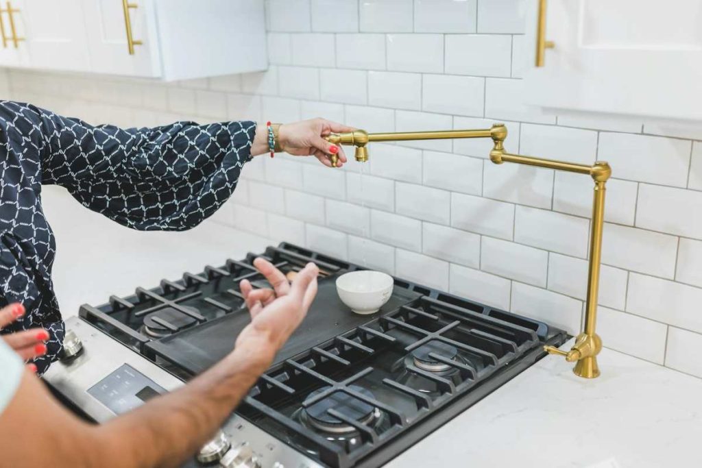 Assorted fixtures and appliances for house construction, including lighting, faucets, and cabinetry, highlighting the variety of owner-supplied items.