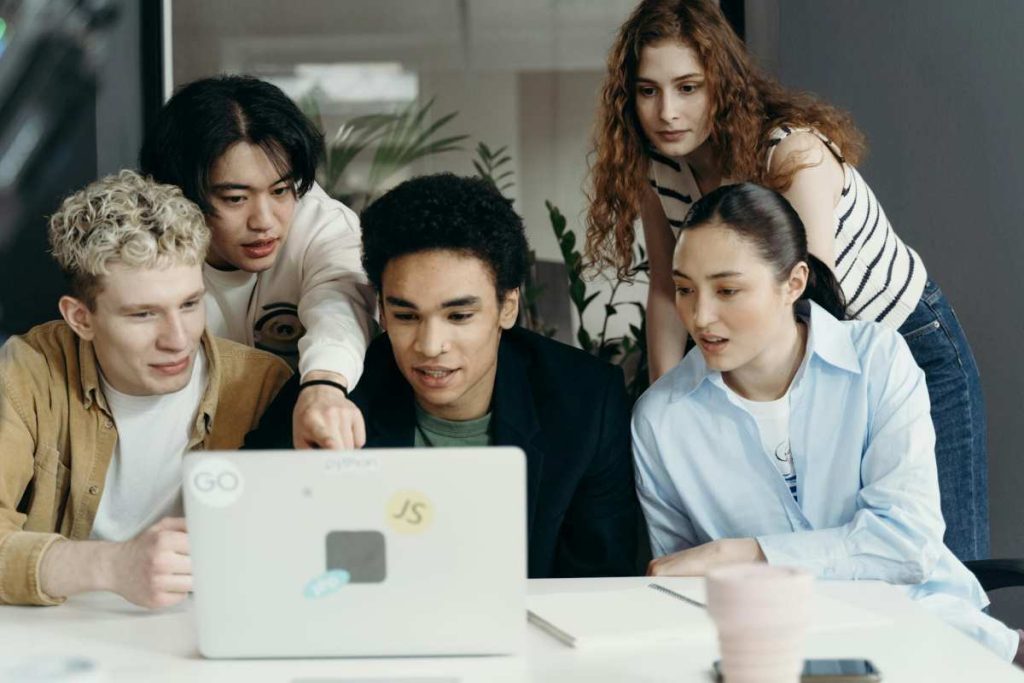 Group of architects and engineers collaborating around a table, discussing AI technology integration into their workflow, emphasizing teamwork and innovation in the architecture industry.