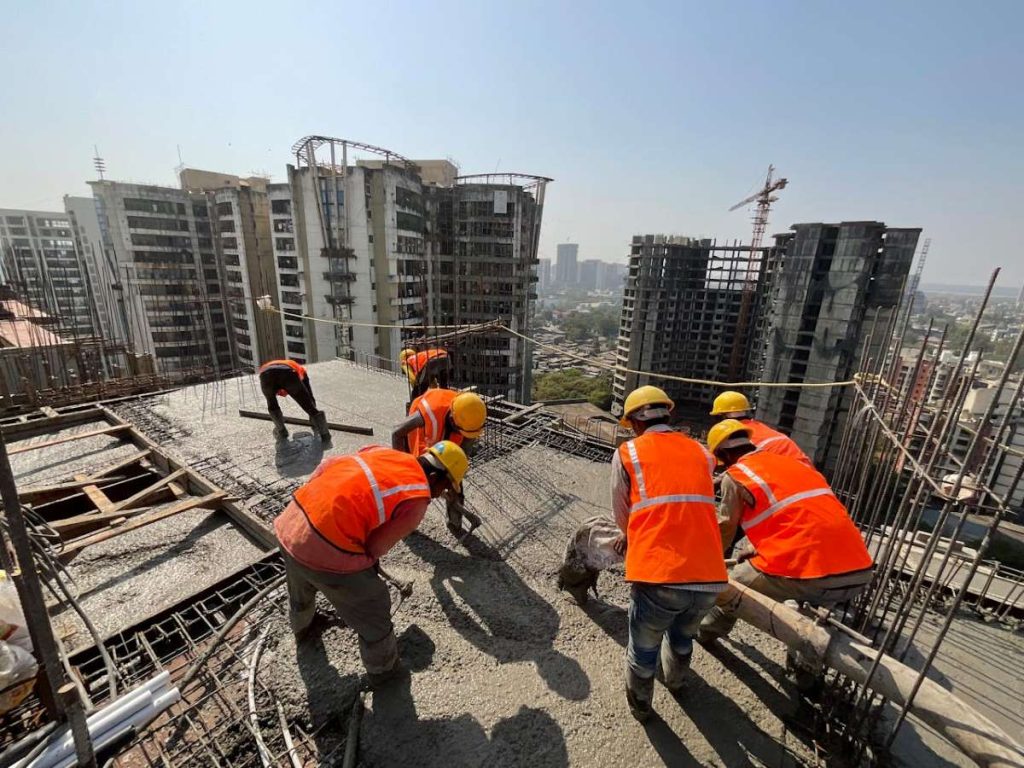 Construction workers on-site and buildings under development, representing the impact of tax incentives from the Omnibus Investments Code of 1987